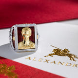 Gold ring with a portrait on a red and white box labeled 'Alexandria'.