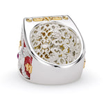 Luxury ring with intricate design and gemstones on a white background