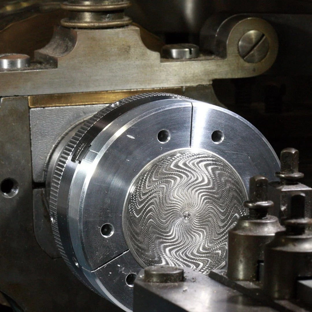 Guilloché rose engine lathe close-up of a metal lathe with a detailed metal object being machined